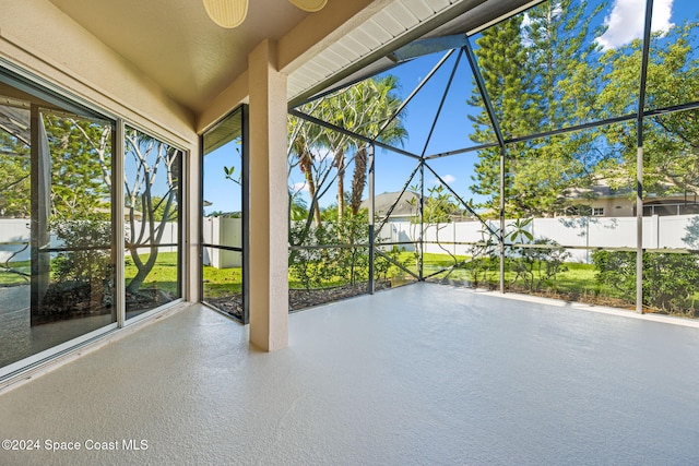 unfurnished sunroom featuring ceiling fan