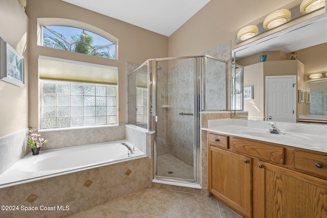 bathroom featuring tile patterned floors, vanity, separate shower and tub, and lofted ceiling