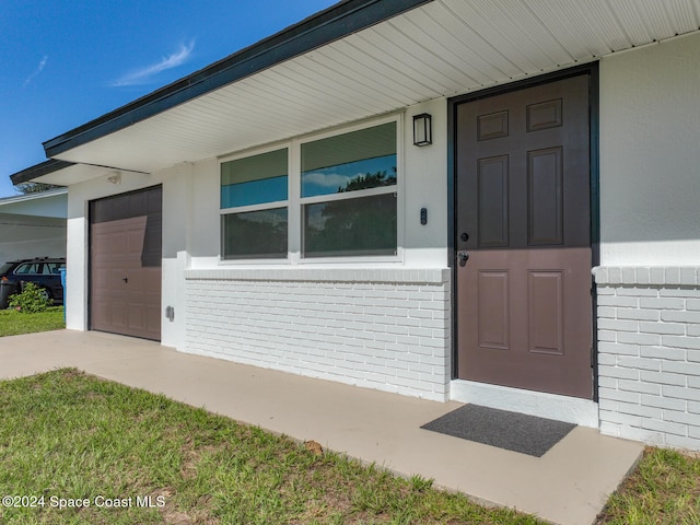 view of exterior entry with a garage