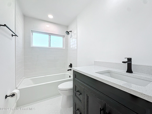 full bathroom featuring vanity, toilet, tile patterned floors, and tiled shower / bath combo