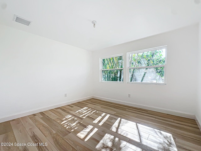 unfurnished room with light hardwood / wood-style flooring