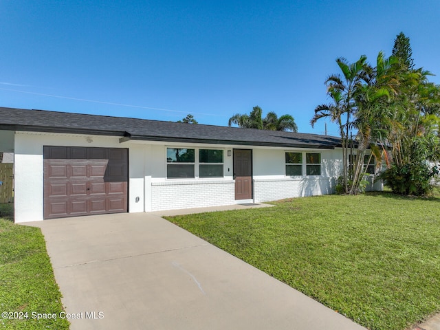 ranch-style home with a front yard and a garage