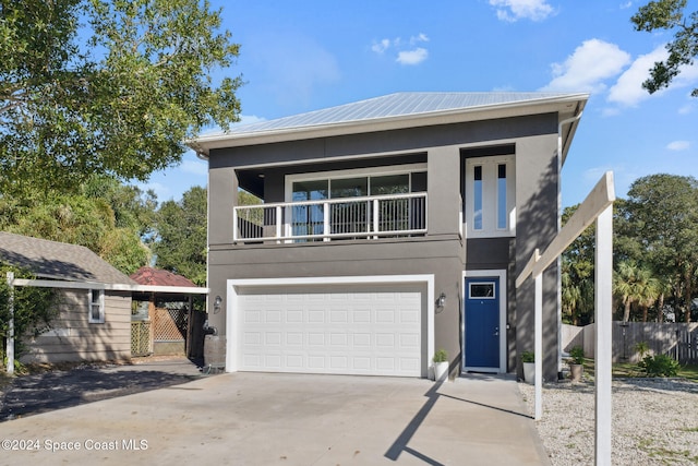 view of front of property with a balcony and a garage