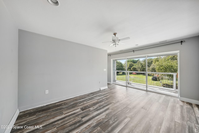 empty room featuring ceiling fan and dark hardwood / wood-style floors