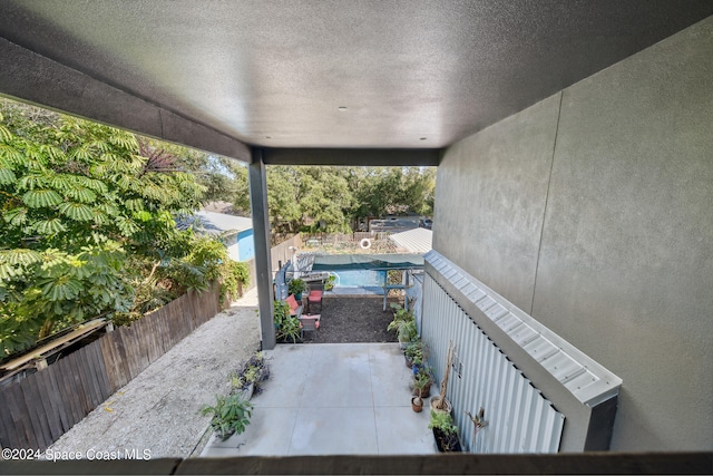 view of patio featuring a fenced in pool