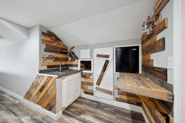 kitchen featuring lofted ceiling, white cabinets, sink, and dark hardwood / wood-style flooring