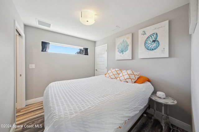 bedroom with hardwood / wood-style flooring