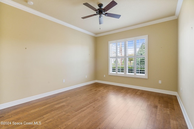 unfurnished room featuring hardwood / wood-style flooring, ceiling fan, and crown molding