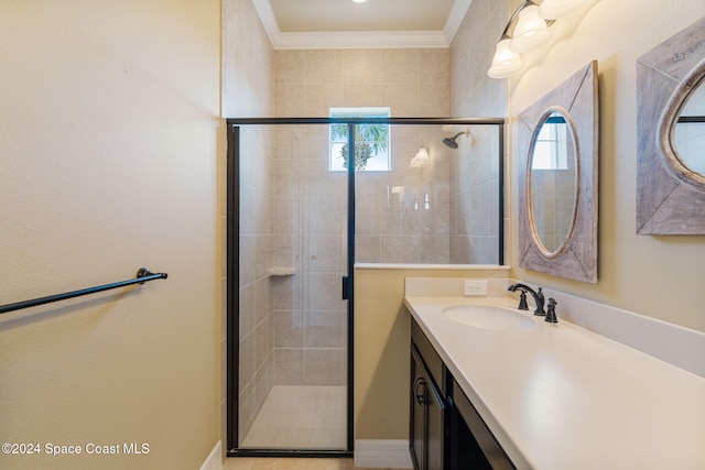 bathroom with walk in shower, vanity, and crown molding