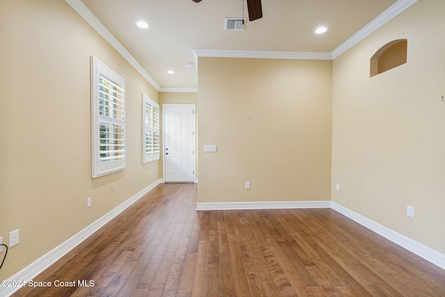 spare room featuring ceiling fan, wood-type flooring, and ornamental molding