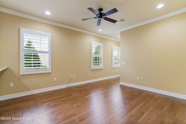 empty room featuring ceiling fan, wood-type flooring, a healthy amount of sunlight, and ornamental molding