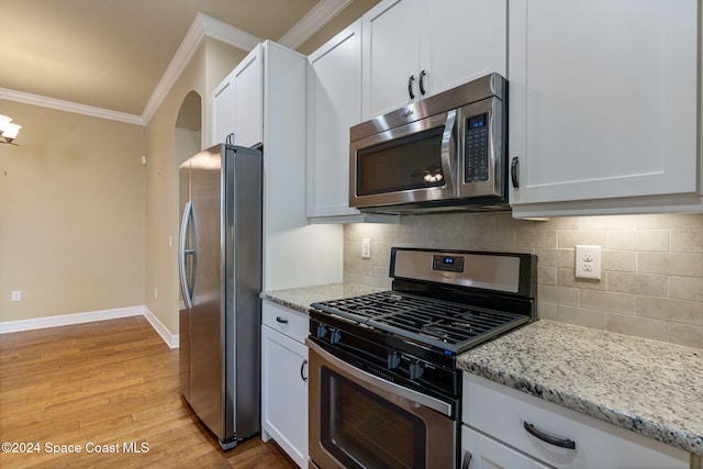 kitchen featuring white cabinets, light hardwood / wood-style flooring, and appliances with stainless steel finishes