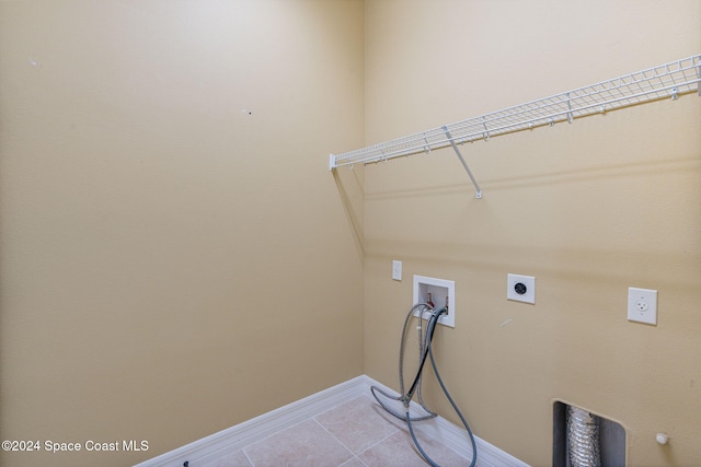 laundry room with hookup for a washing machine, electric dryer hookup, and light tile patterned floors