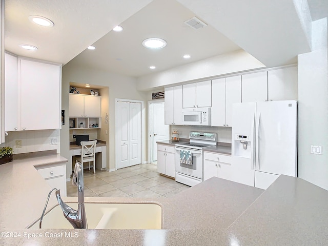 kitchen featuring white appliances, light tile patterned floors, sink, and white cabinets