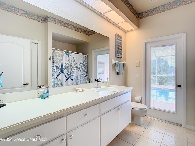 bathroom with vanity, toilet, and tile patterned flooring