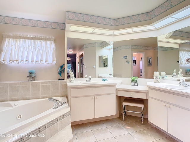 bathroom with vanity, a relaxing tiled tub, and tile patterned flooring