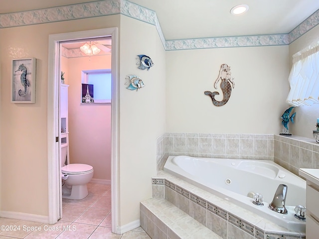 bathroom featuring vanity, tiled bath, toilet, and tile patterned flooring