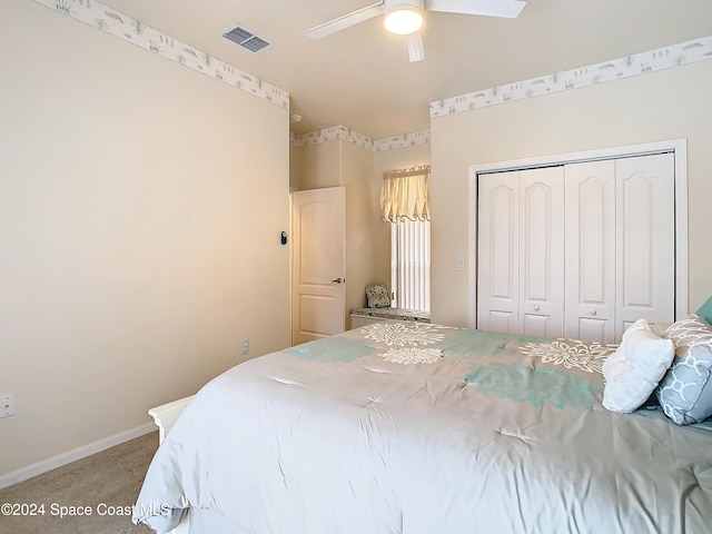 carpeted bedroom featuring a closet and ceiling fan