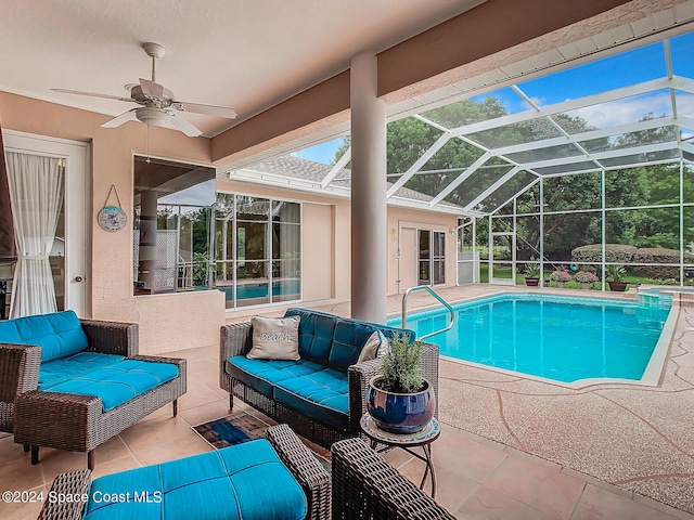 view of pool with a patio, ceiling fan, glass enclosure, and outdoor lounge area