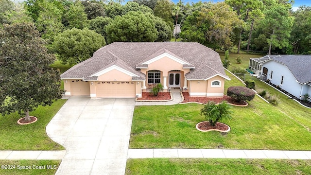 view of front facade with a front yard and a garage