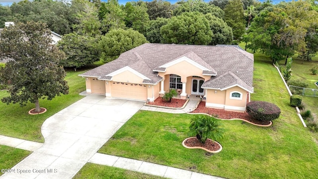 view of front of home featuring a front yard and a garage