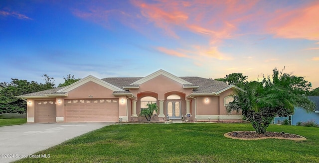 ranch-style house with a yard and a garage