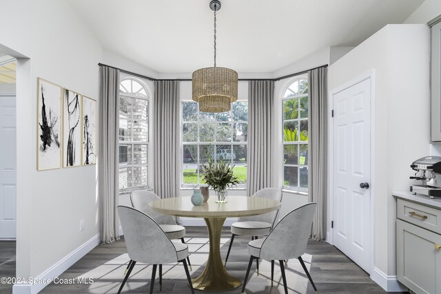 480 Prestwick Ct, Melbourne, FL 32940 - dining room featuring dark wood-style flooring, a notable chandelier, and a wealth of natural light