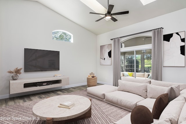 living room with hardwood / wood-style floors, high vaulted ceiling, and ceiling fan