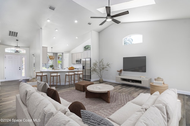 living room with dark hardwood / wood-style floors, high vaulted ceiling, and ceiling fan