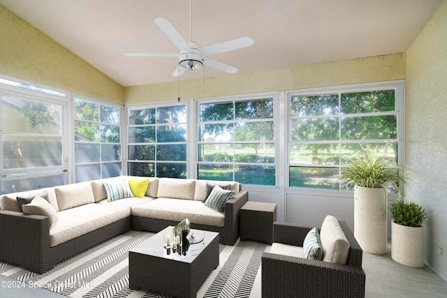 sunroom with ceiling fan, plenty of natural light, and vaulted ceiling