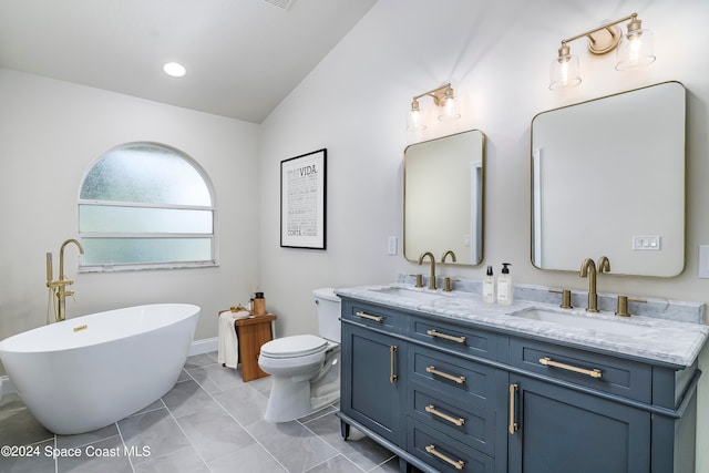 bathroom featuring toilet, a tub to relax in, tile patterned flooring, vaulted ceiling, and vanity