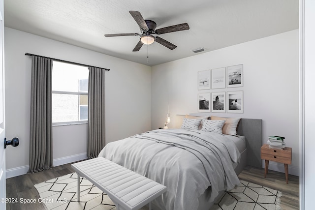 bedroom featuring dark hardwood / wood-style floors and ceiling fan