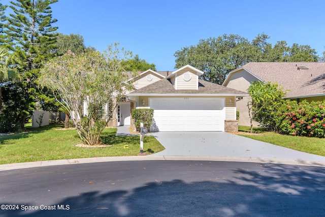 view of front of home with a front lawn and a garage