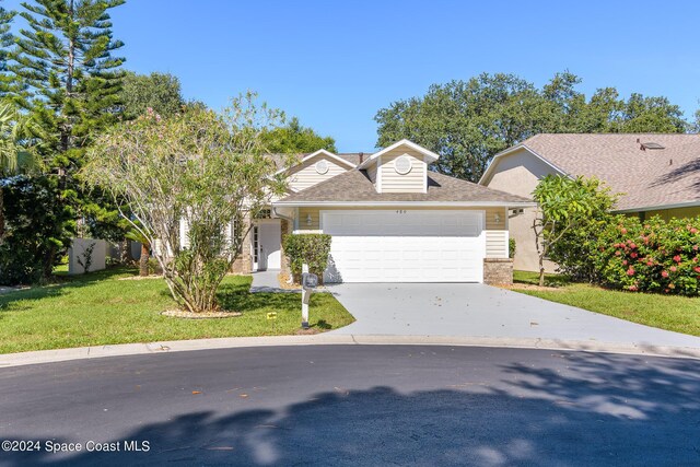 480 Prestwick Ct, Melbourne, FL 32940 - view of front of home with an attached garage, roof with shingles, driveway, and a front yard