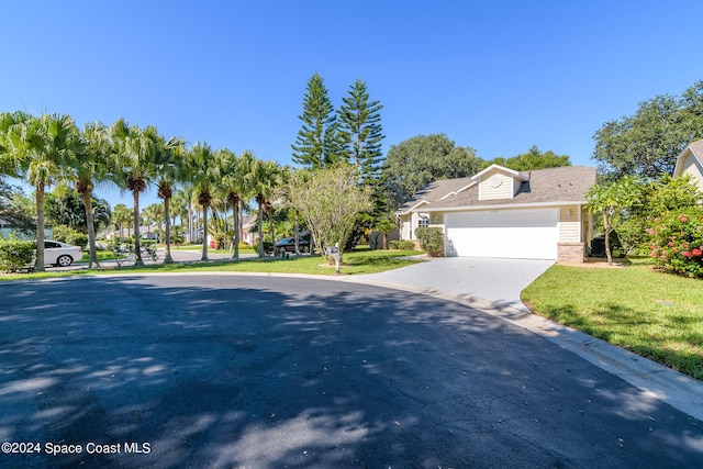 view of front of home featuring a front yard and a garage