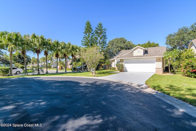 480 Prestwick Ct, Melbourne, FL 32940 - view of front of house with an attached garage, concrete driveway, a front lawn, and brick siding