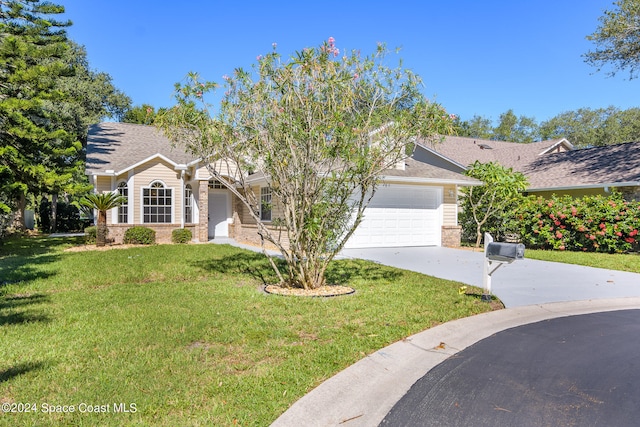 view of front facade featuring a front yard and a garage