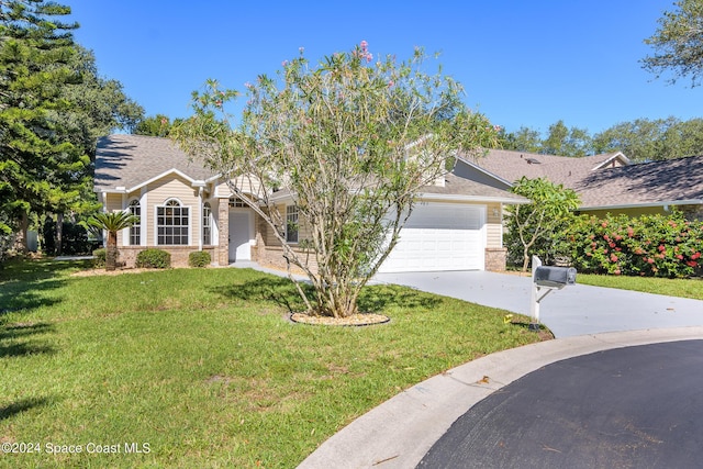 480 Prestwick Ct, Melbourne, FL 32940 - view of front of house with brick siding, a front lawn, concrete driveway, an attached garage, and a shingled roof