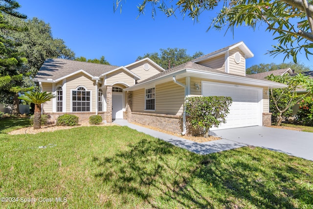 ranch-style home featuring a front yard and a garage