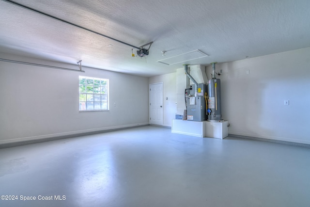 garage featuring gas water heater, heating unit, and a garage door opener