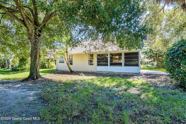 480 Prestwick Ct, Melbourne, FL 32940 - rear view of house with a sunroom and a lawn