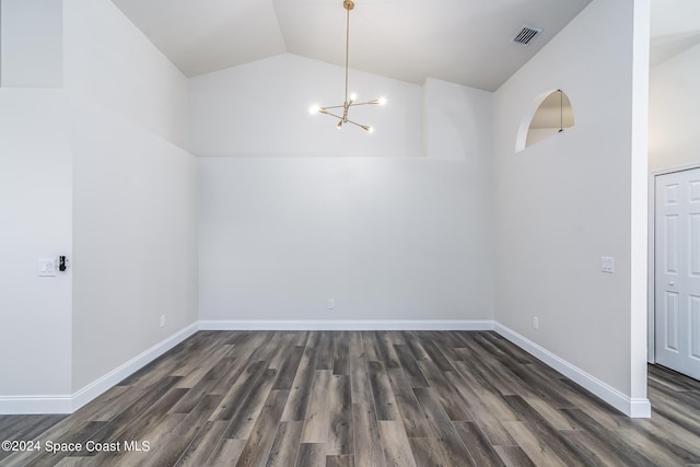 interior space featuring dark wood-type flooring, vaulted ceiling, and a chandelier