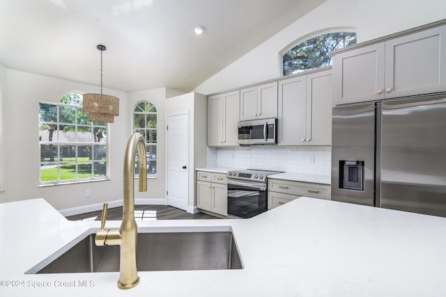480 Prestwick Ct, Melbourne, FL 32940 - kitchen with a sink, light countertops, stainless steel appliances, decorative backsplash, and gray cabinetry