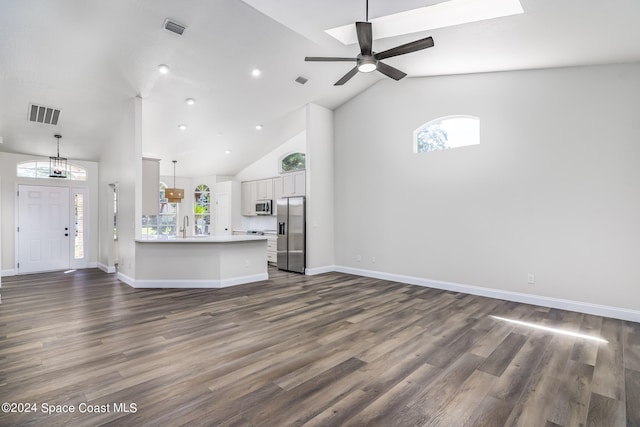 unfurnished living room with dark wood-type flooring, high vaulted ceiling, and ceiling fan