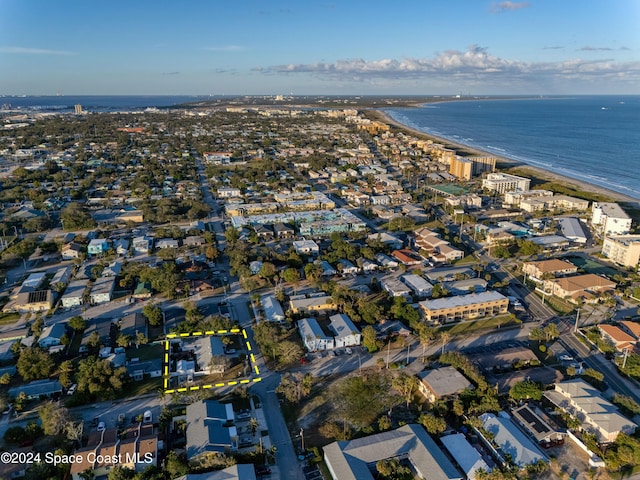 drone / aerial view featuring a water view and a view of the beach