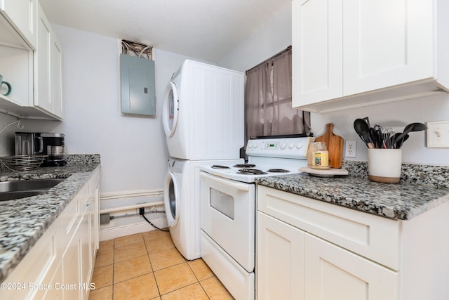 interior space featuring electric panel, light tile patterned flooring, and stacked washing maching and dryer