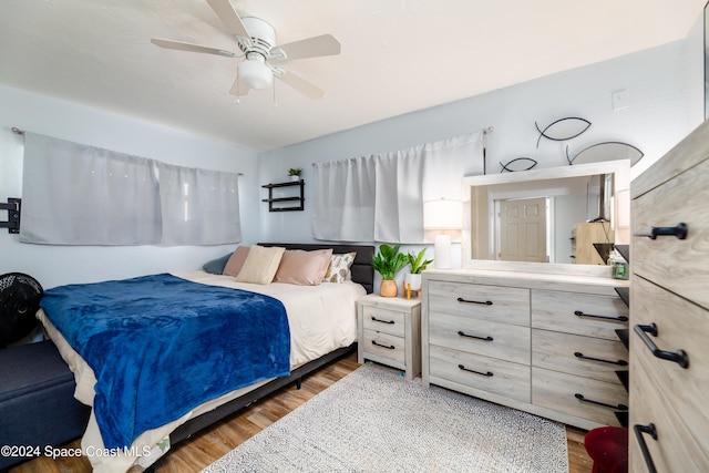 bedroom with hardwood / wood-style flooring and ceiling fan