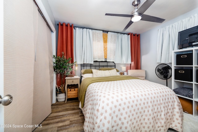 bedroom featuring wood-type flooring, a closet, and ceiling fan