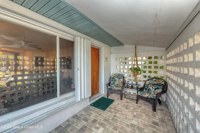 sunroom / solarium with ceiling fan and lofted ceiling