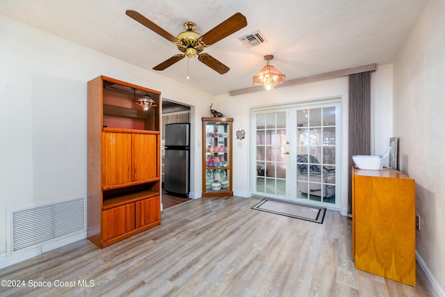 unfurnished living room featuring light hardwood / wood-style floors and ceiling fan